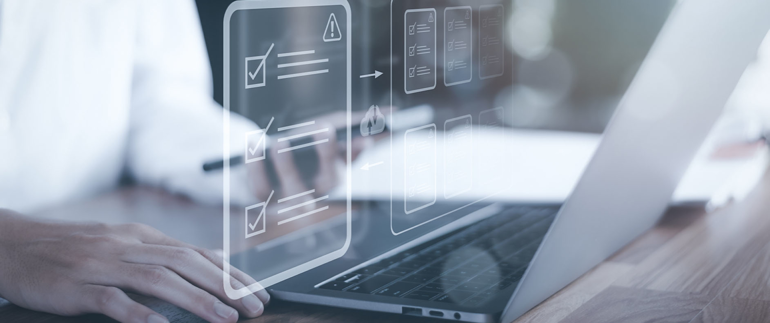 Person vor Laptopbildschirm und Hologramm mit Normen und Regeln, welche die EliteBuildingArchiTec befolgt